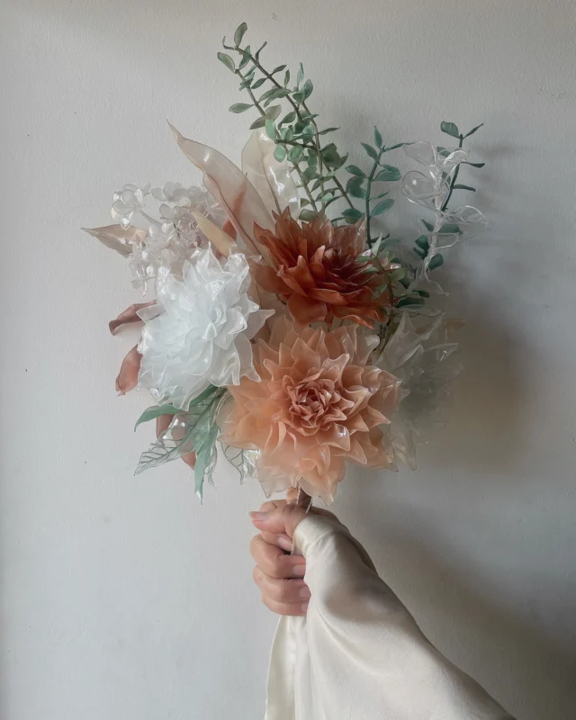 拘ったのは、、

バランス、空間と隙間、形状と色味。
他にも多々あるのですが、考えながら制作している為、とにかく言葉にするのが難しい。。
備忘録的なキャプションですm(_ _)m

ご依頼時の参考写真を基に、ペットボトルアートフラワーならではの魅力が出せるように、生花＋ドライフラワーなイメージで制作開始。

"綺麗に見える"のみに注力できる一輪の花とは違い、ブーケの様な組合わせの作品は全体のバランスにとても気を使います。
あくまでも硬いプラ（ペットボトル）な為、パーツ毎に綺麗さを優先してしまうと、組合せる際に意図しない空間や隙間が生じてしまう。
そんな隙間ができないように、逆算する？イメージで花や葉のパーツを制作します。

これ！と言ったセオリーがないため、言葉で現すと『感覚 & 自己満』になってしまいます。が、組合せる際の空間の造り方、意図しない隙間の使い方など、まだまだ発展途上日々勉強です。

ちょっと長くなってきましたが、
今作品の一番の拘りポイントは、実は色味/着色です。着色のメイン塗料はパステルですが、制作開始時から柿渋染の花（4枚目）をメインでありながら脇役に据えたかったため、濃すぎず薄すぎず、、染め具合に時間を費やしました。

あくまでも主観（自己満）ですが、良〜い感じの色味に仕上がったかなと。
因みに柿渋染のペットボトルフラワーは柿渋液が仄かに香ります🤭

［制作依頼作品］Wedding Bouquet
————

接着剤、針金未使用
my artwork do not contain wires, adhesives. Just plastic-bottles.

#柿渋 #柿渋染め #天然染料
Cheers; @san_yuu1857 

#ペットボトルアート #ゴミアート #plasticbottleart #plasticbottleflowers #upcycledart #trashart #recycledart #weddingbouquet #結婚式 #ブーケ